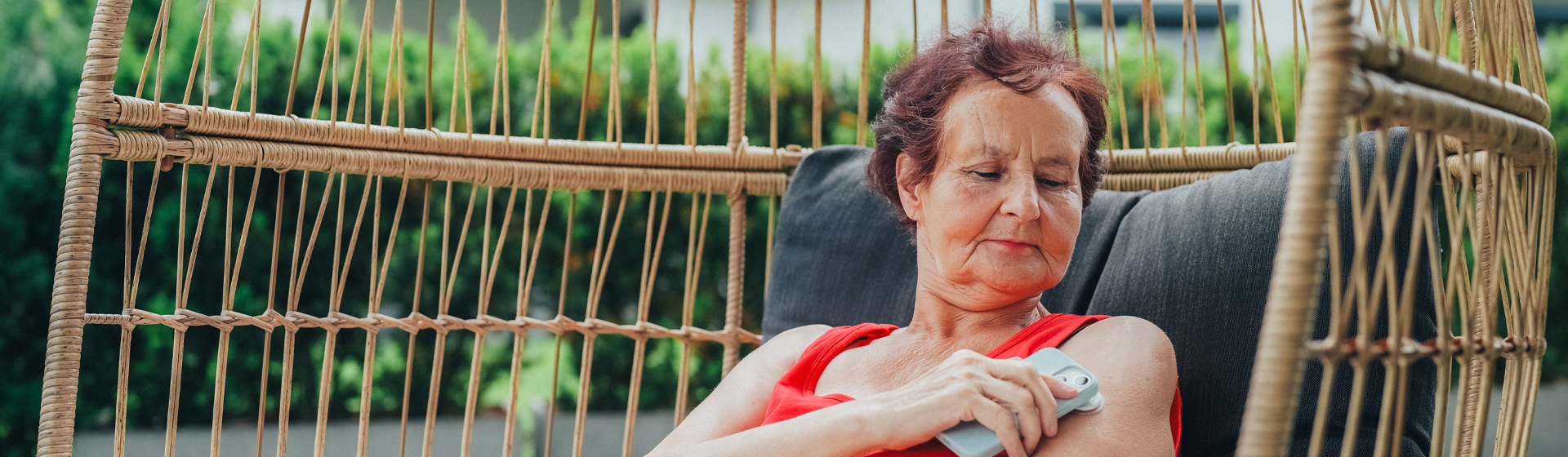 Woman tests glucose levels while lounging in chair