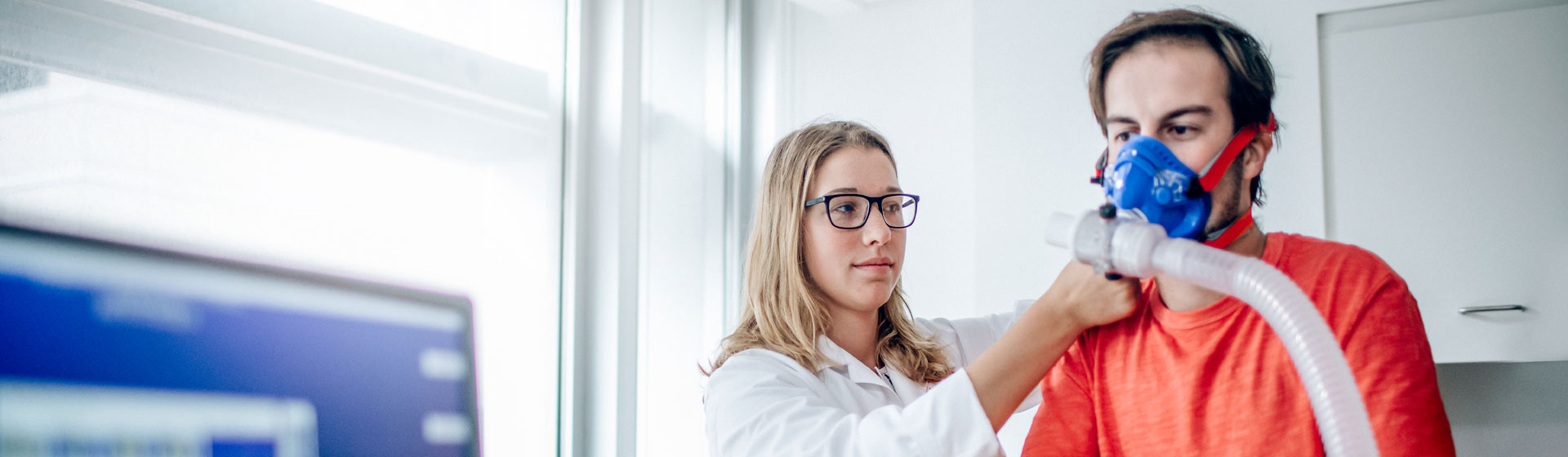 Female Researcher Conducting a Test on a Male Patient