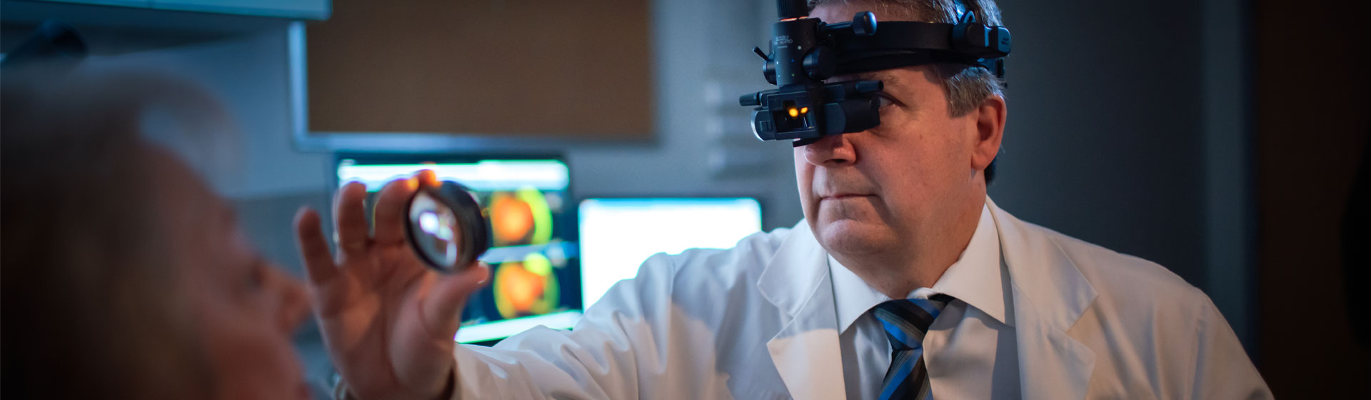 Male eye doctor with a patient