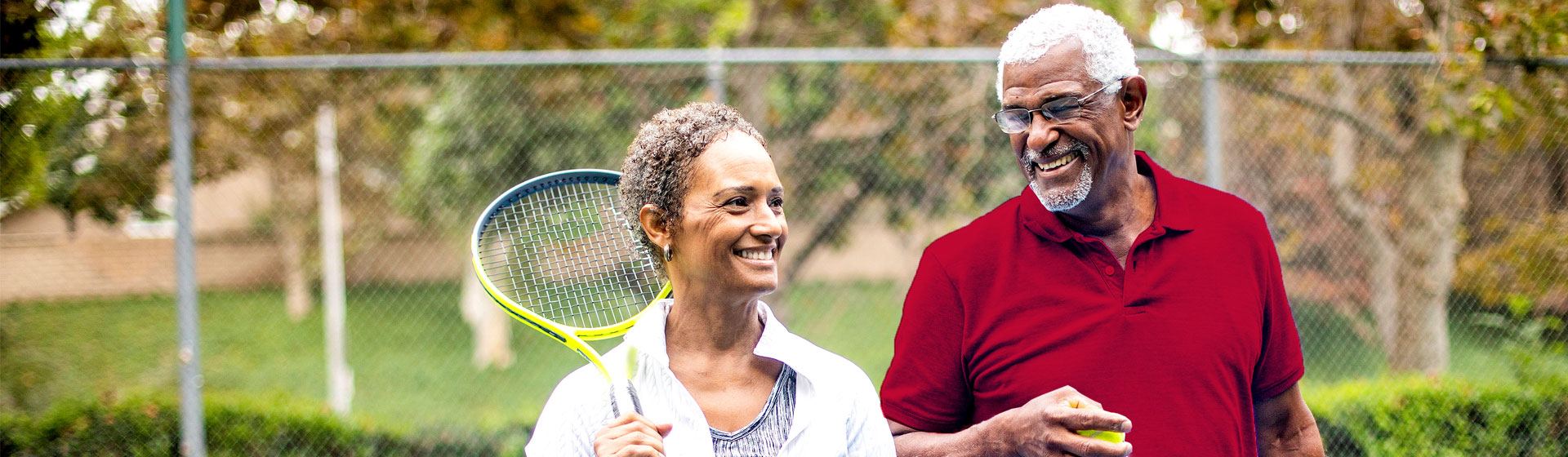 African American couple playing tennis