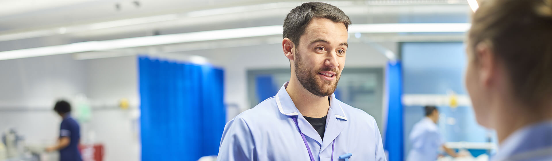 Medical fellow speaking with peer