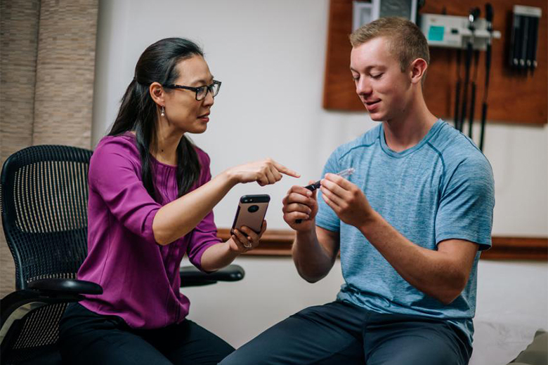 Staff member helping a diabetic patient