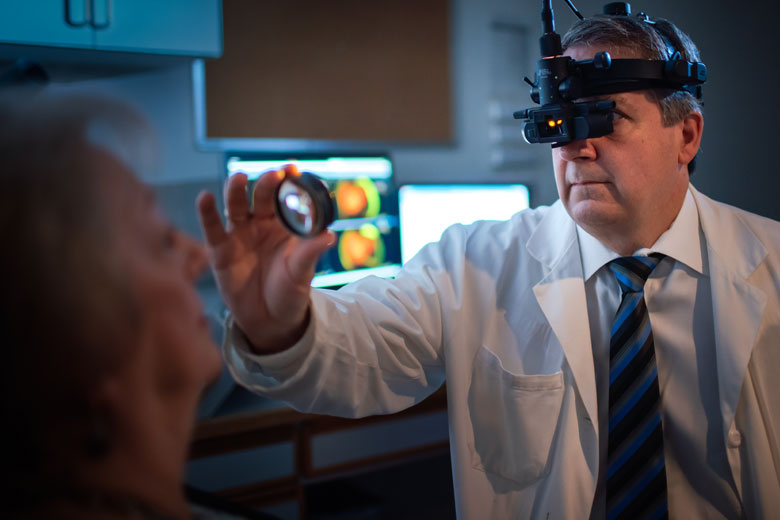 Male eye doctor with a patient