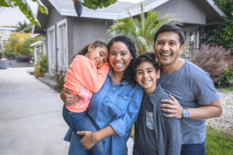 A Hispanic family in front of a house