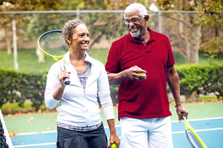 African American couple playing tennis