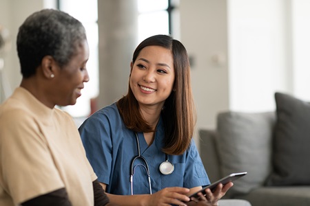 Elderly woman speaking to nurse